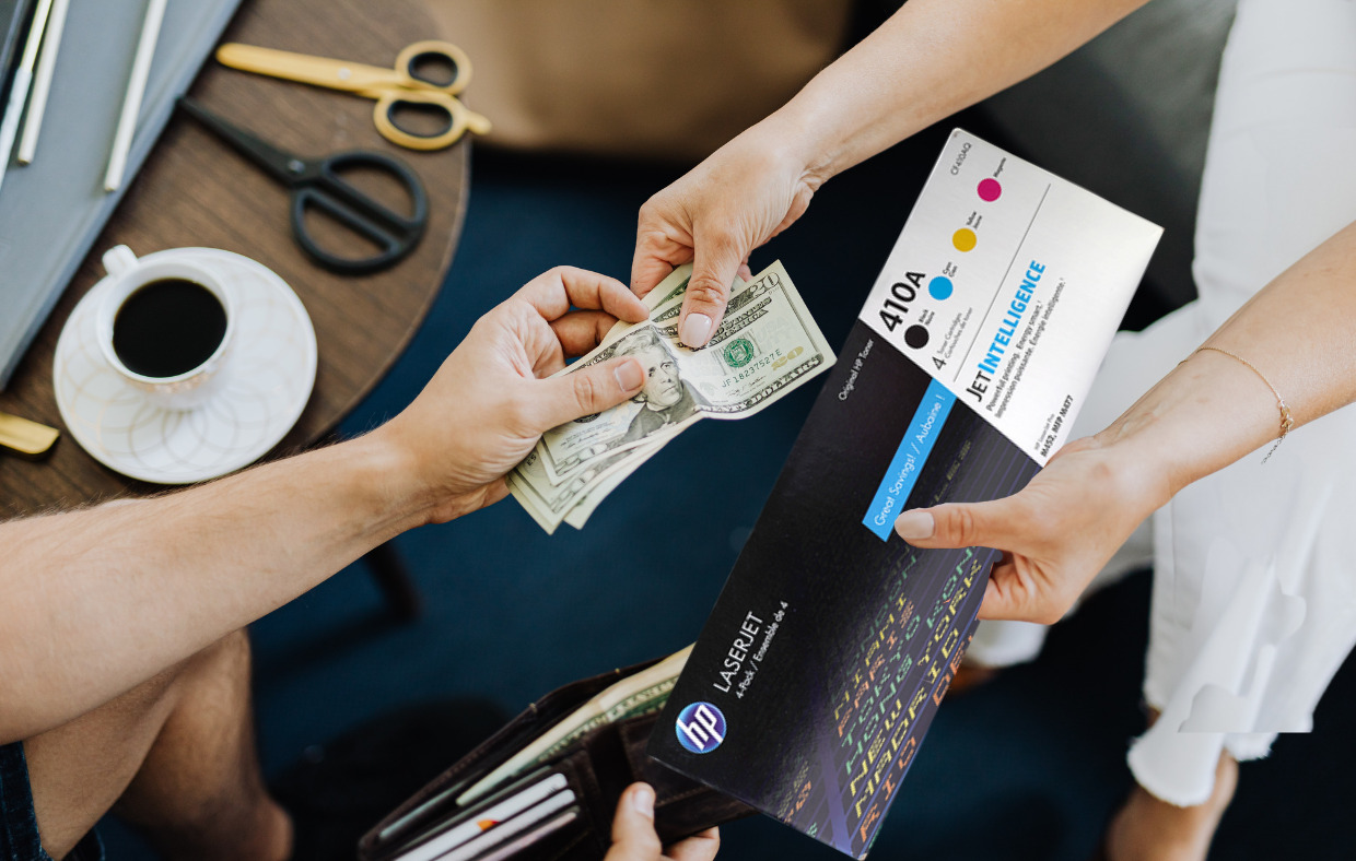 Person selling ink cartridge and taking cash